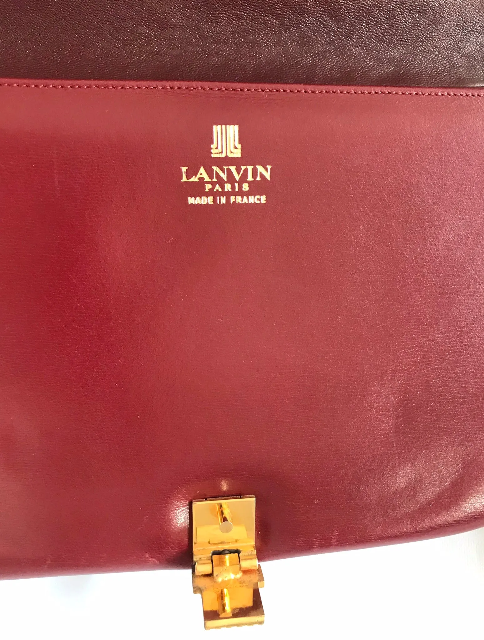 Vintage Lanvin wine leather shoulder bag with golden logo motif closure. Classic must have purse. 060620r2
