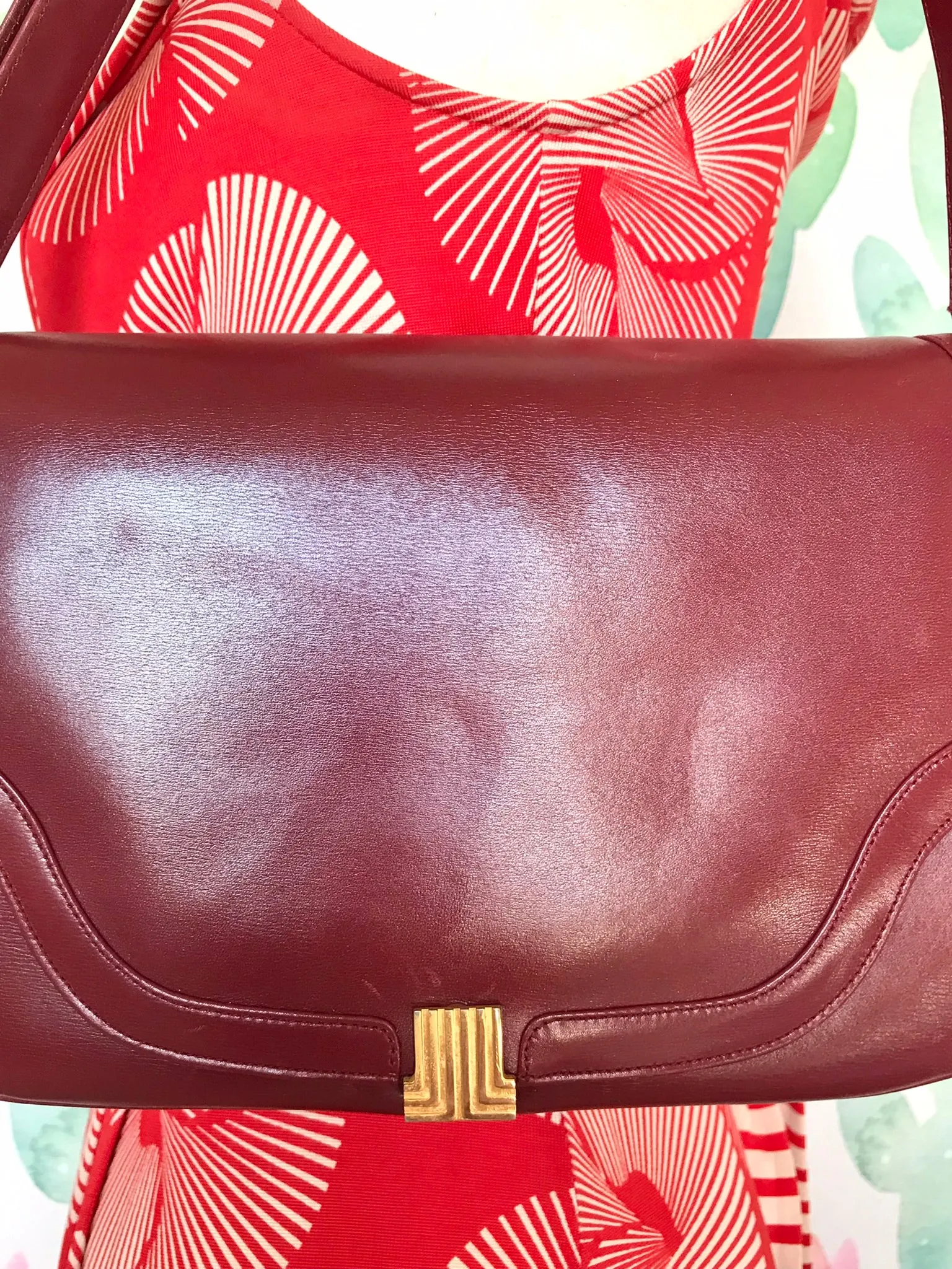 Vintage Lanvin wine leather shoulder bag with golden logo motif closure. Classic must have purse. 060620r2